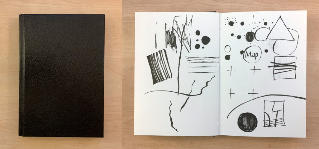 A hardbound black sketchbook closed and opened